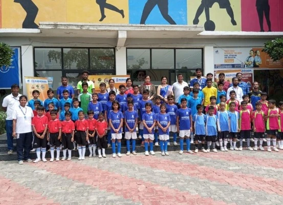 Large group of student sports tournament participants lined up on steps with coaches and teachers